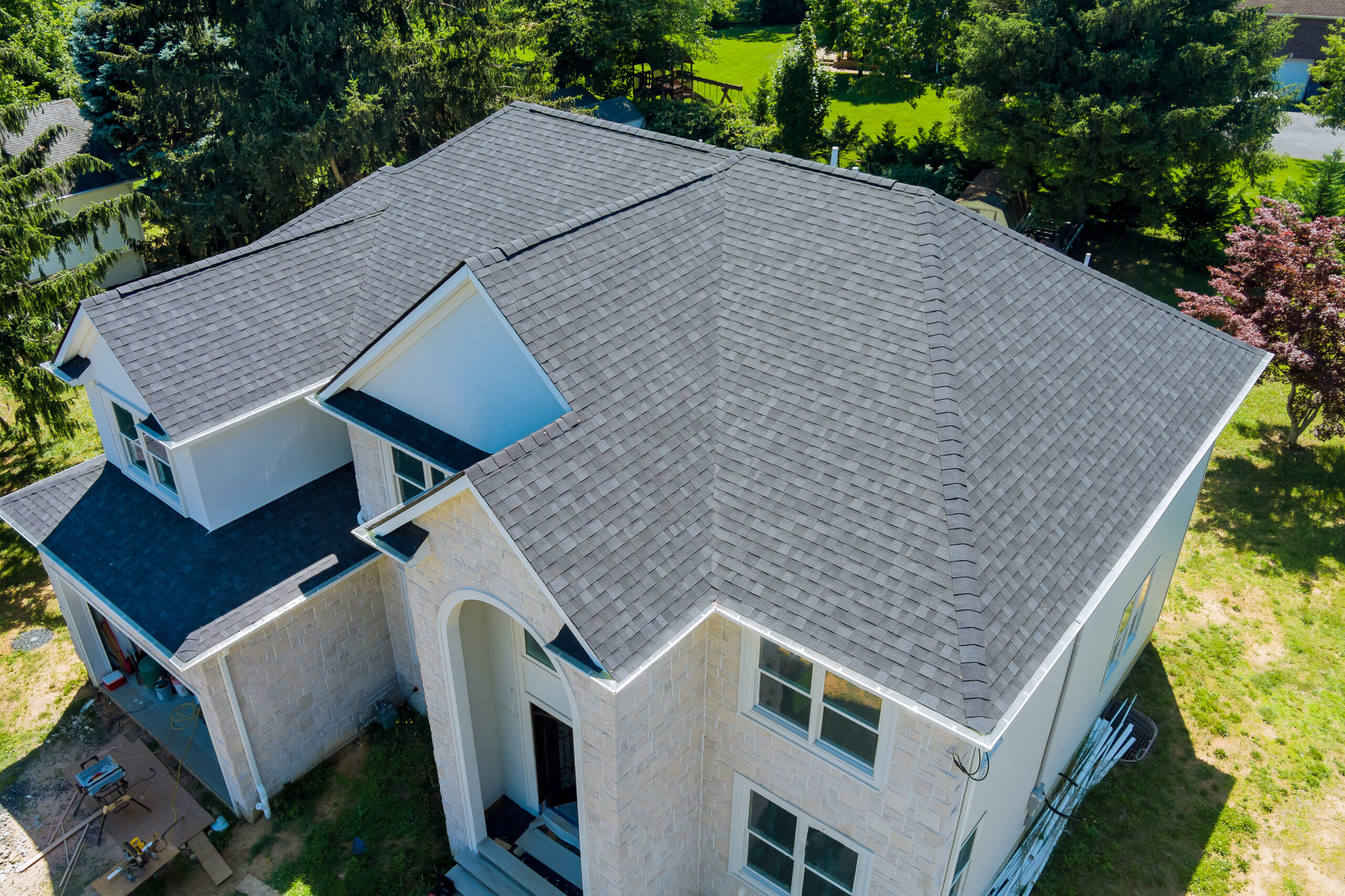 Aerial view of asphalt shingles roofing construction, the house with new window
